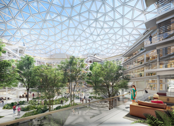 Moderne, lichte atriumruimte van het Boehringer-gebouw met glazen koepeldak, binnentuinen en mensen op verschillende verdiepingen.