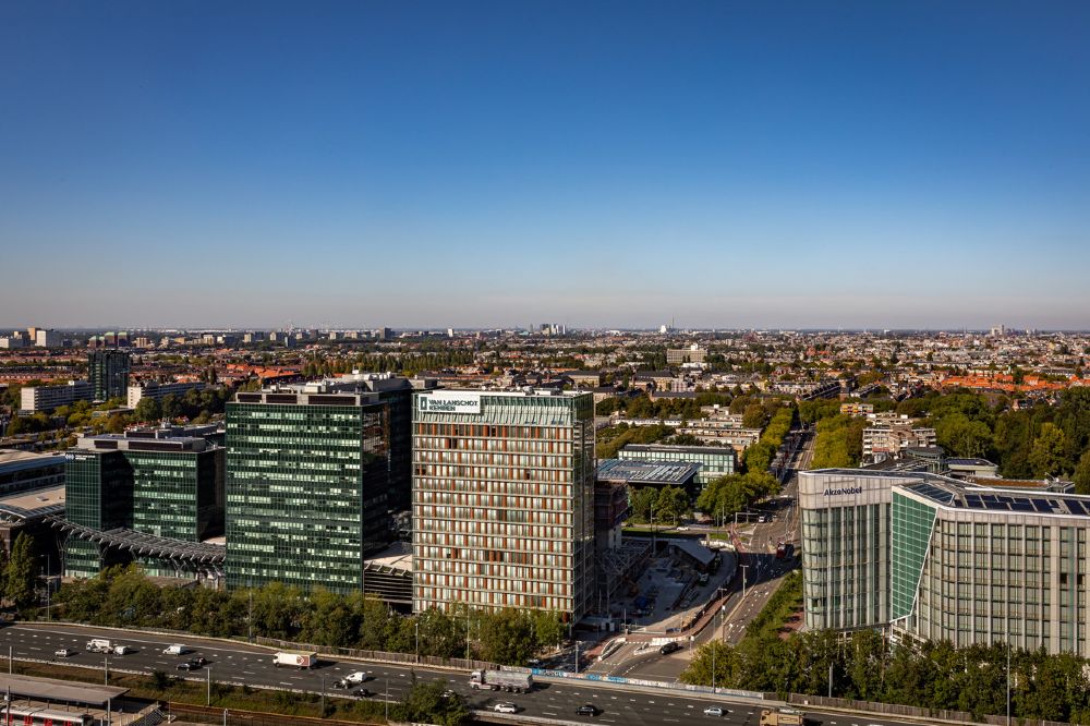 Luchtfoto van het Van Lanschot Kempen-kantoor aan de Beethovenstraat 300 in Amsterdam, omgeven door moderne kantoorgebouwen en stadsgezichten.